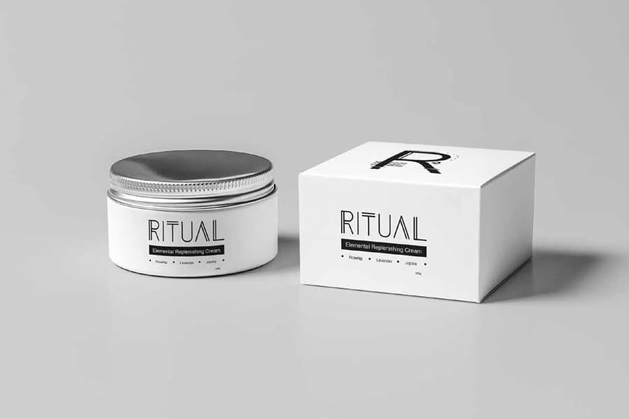 Packaging for Ritual Makeup products in balack and white on a grey background, viewed from the front