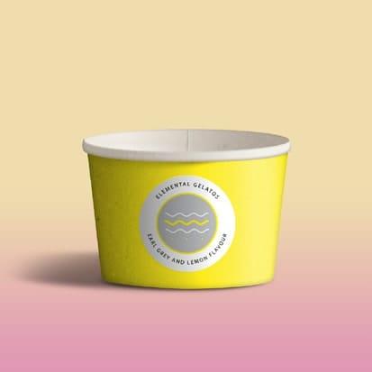 There is an empty gelato cup with an icon depicting a river in front of a pink and yellow background