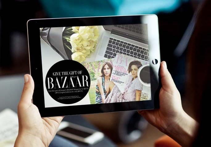 Bazaar website being view pm an iPad by a person sitting on a chair in a living room